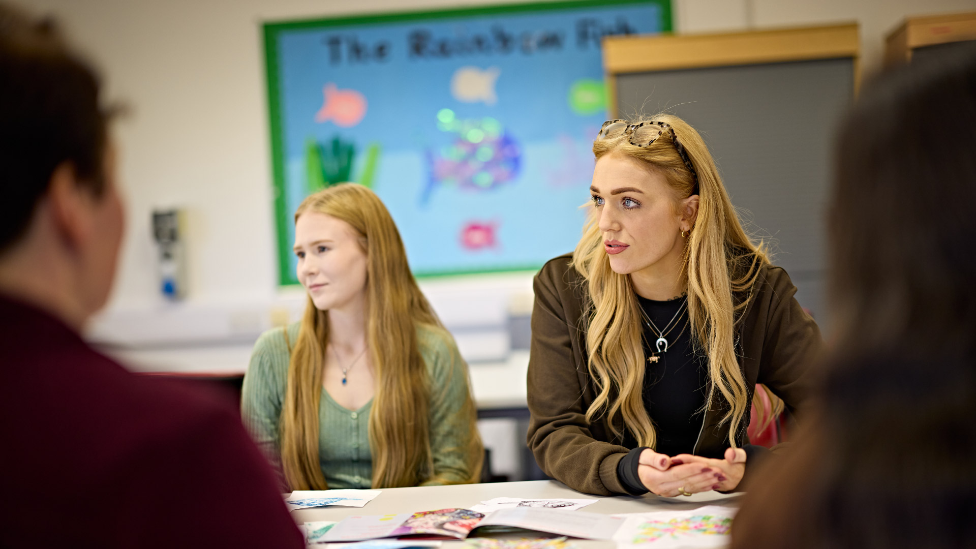 Two students sat in a classroom, learning