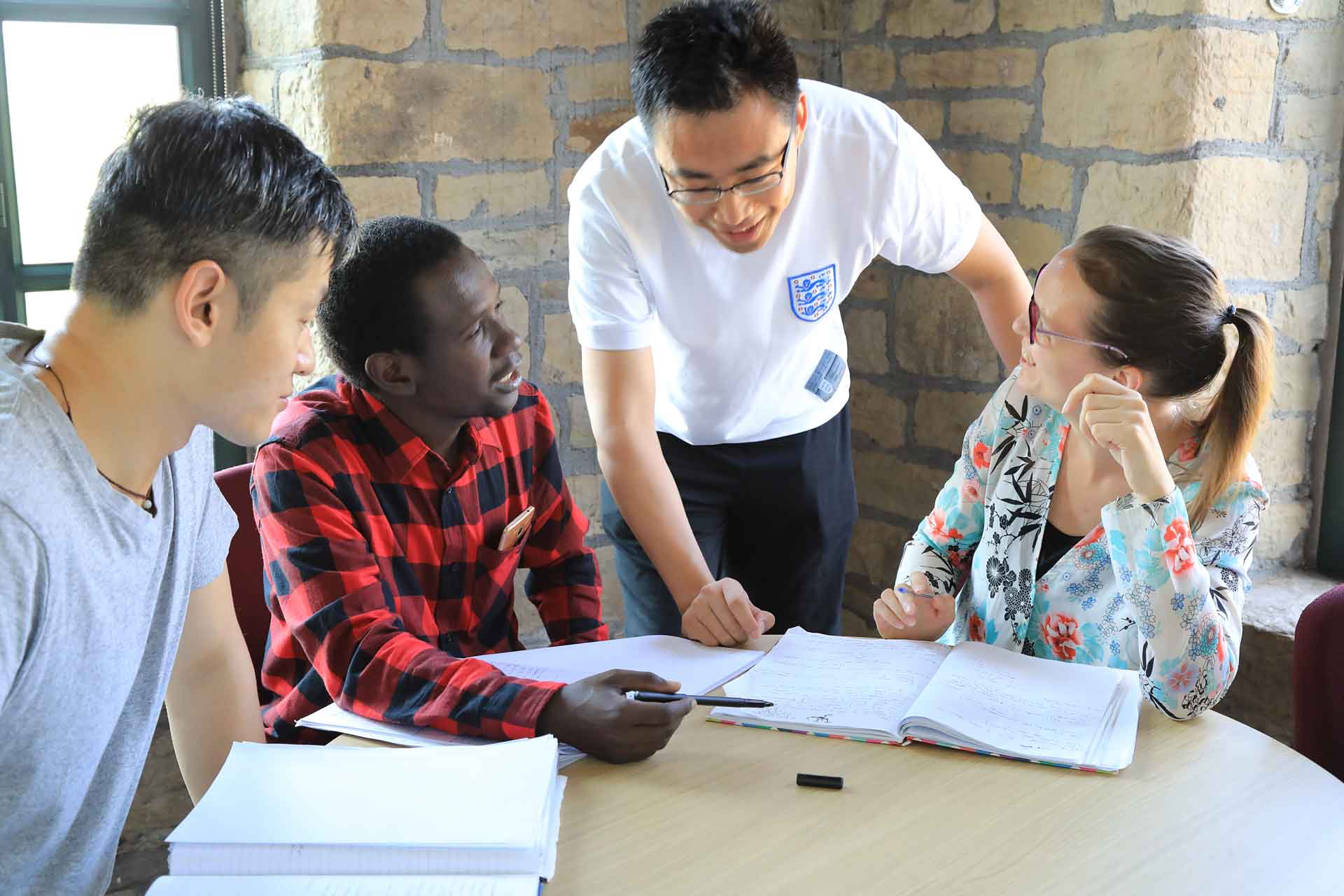 Students engaging in conversation with a member of staff