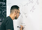 A student writing on a white board