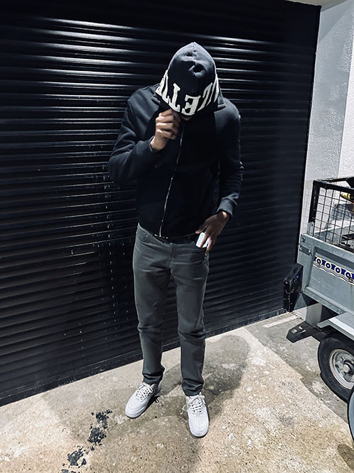 A man wearing jeans and an Allette jacket