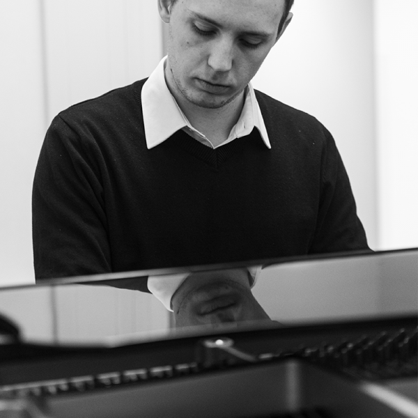 A man sat at a piano