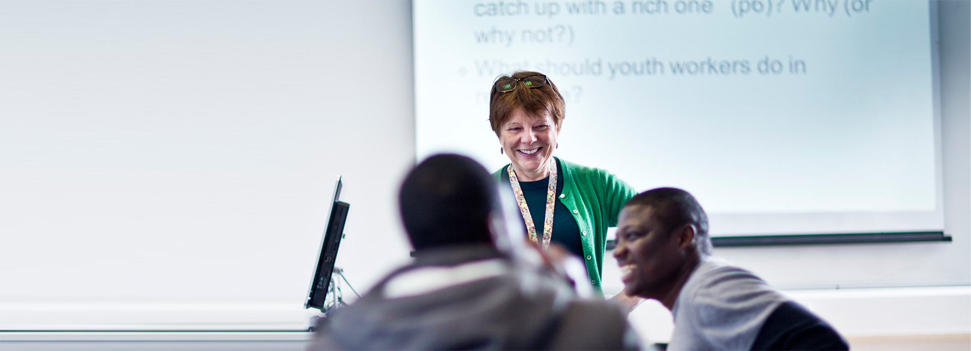 Teacher in classroom mentoring students