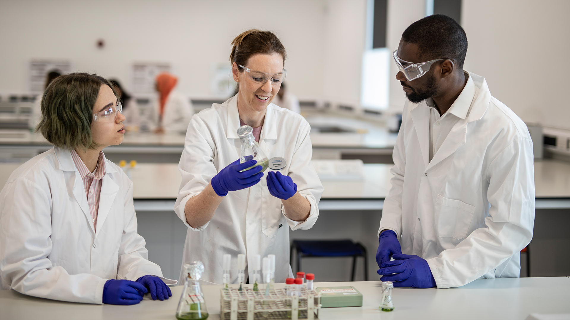 Three people working in a lab.