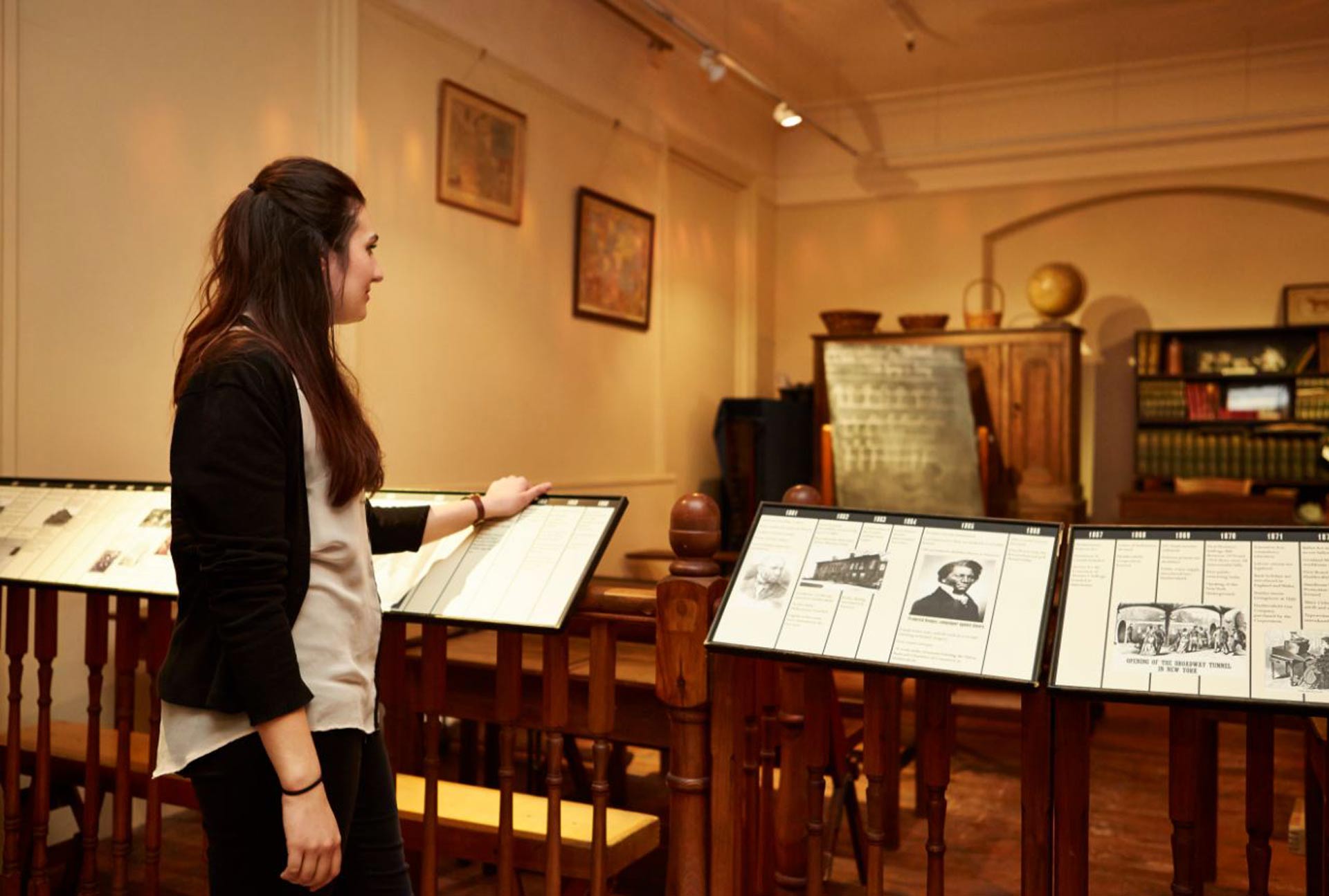 A history student looking at a museum collection