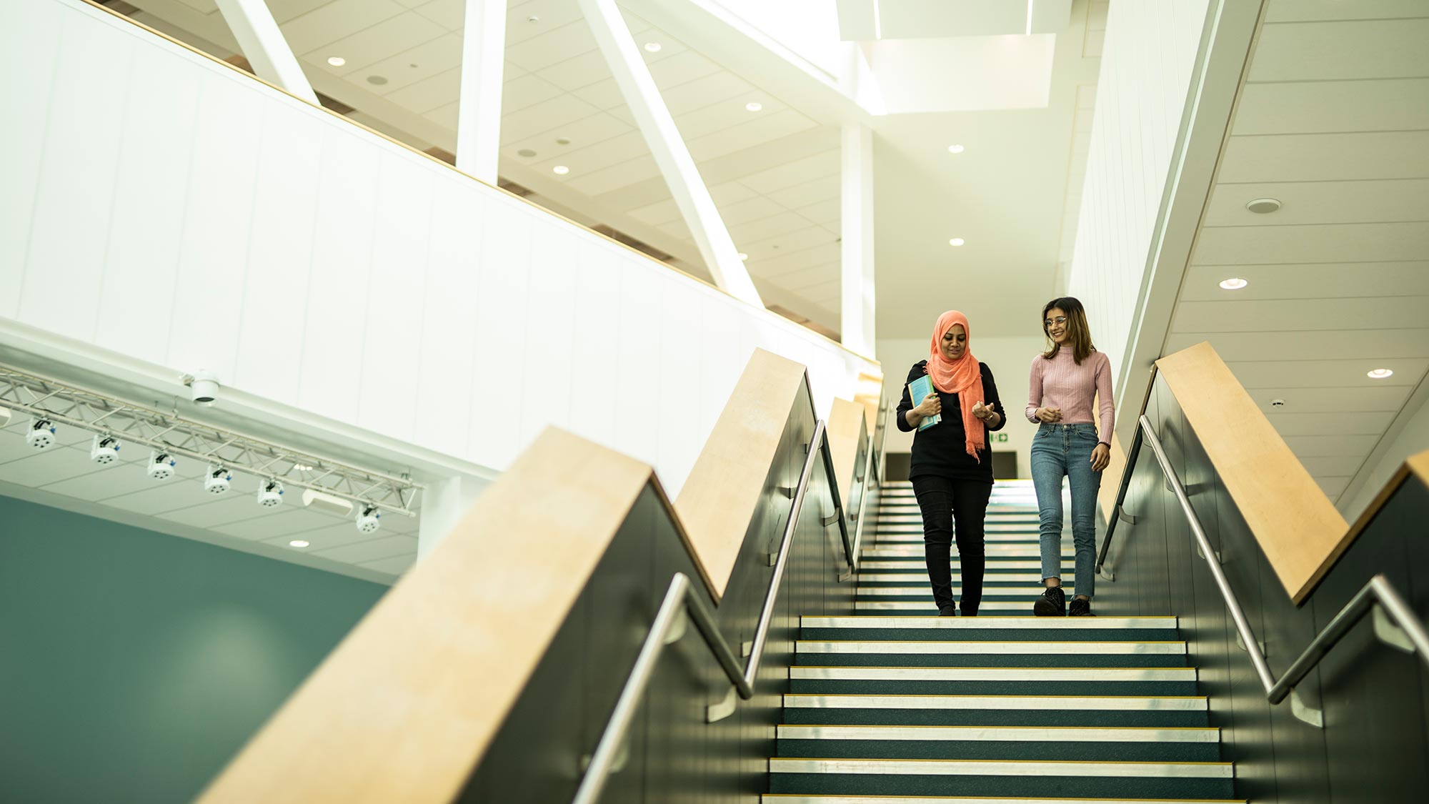 Students walk down the stairs in the Barbara Hepworth Building