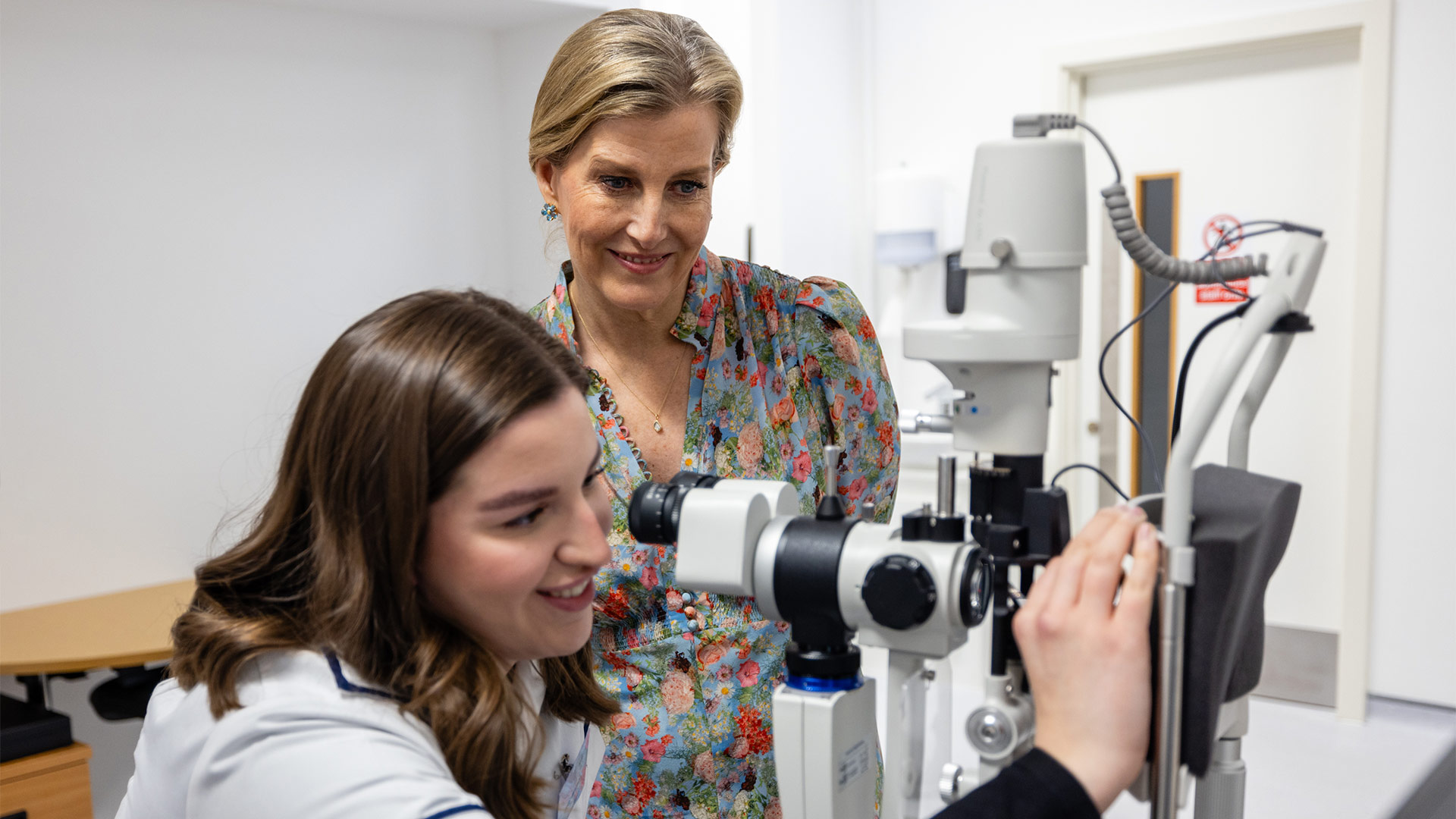 a student showing optometry equipment to The Duchess of Edinburgh