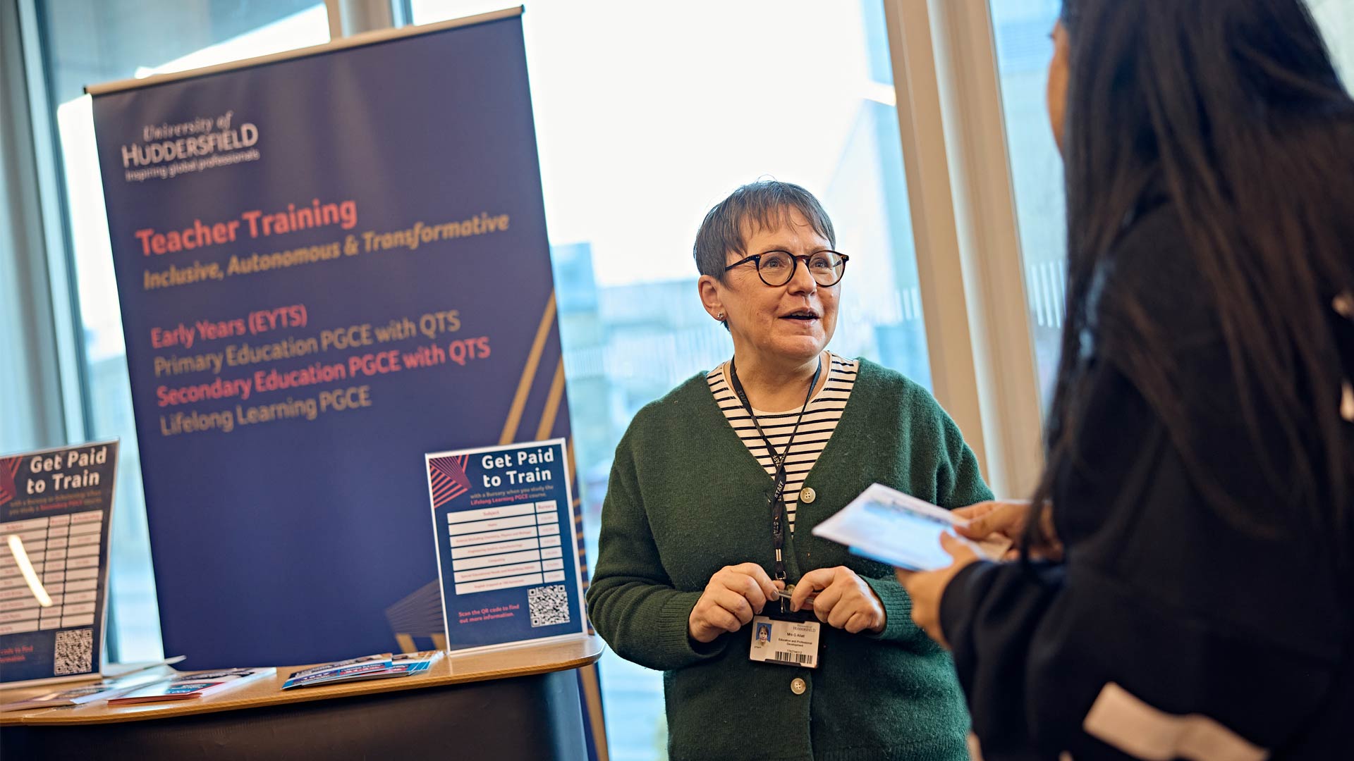 Prospective student speaking to staff member about training to teach at a Postgraduate Open Day