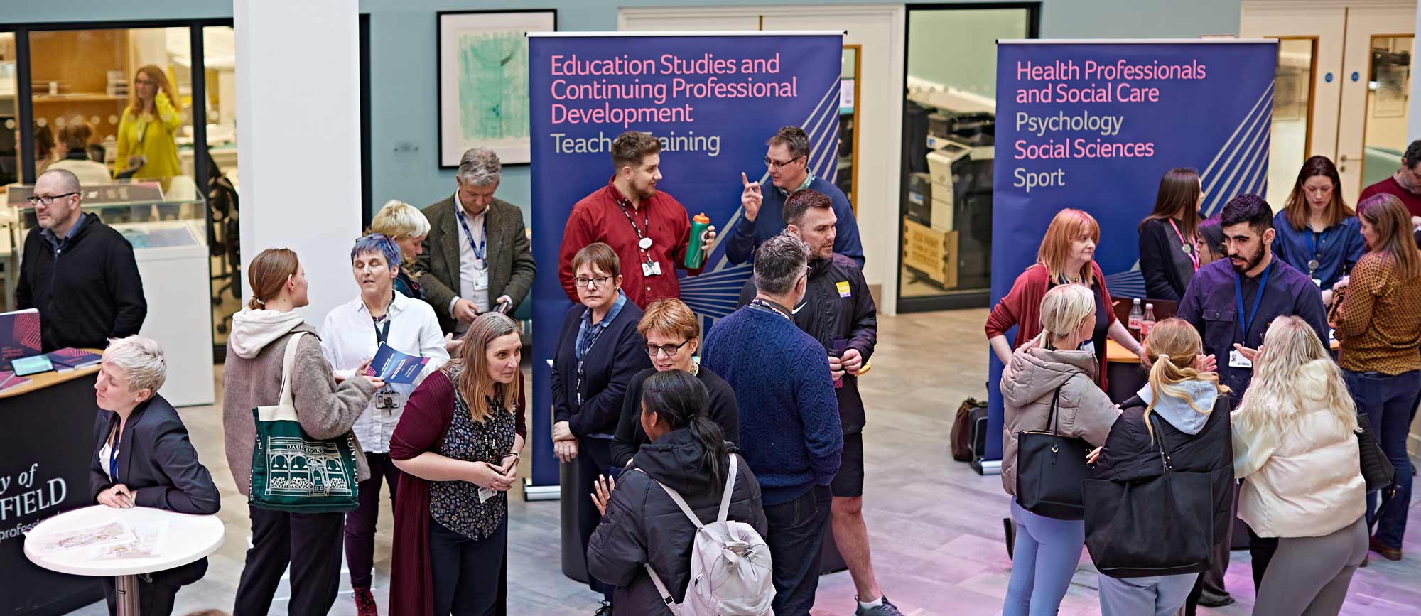 a group of people at the postgraduate study fair