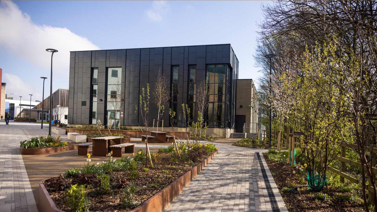 side of jo cox building with flowers in the foreground