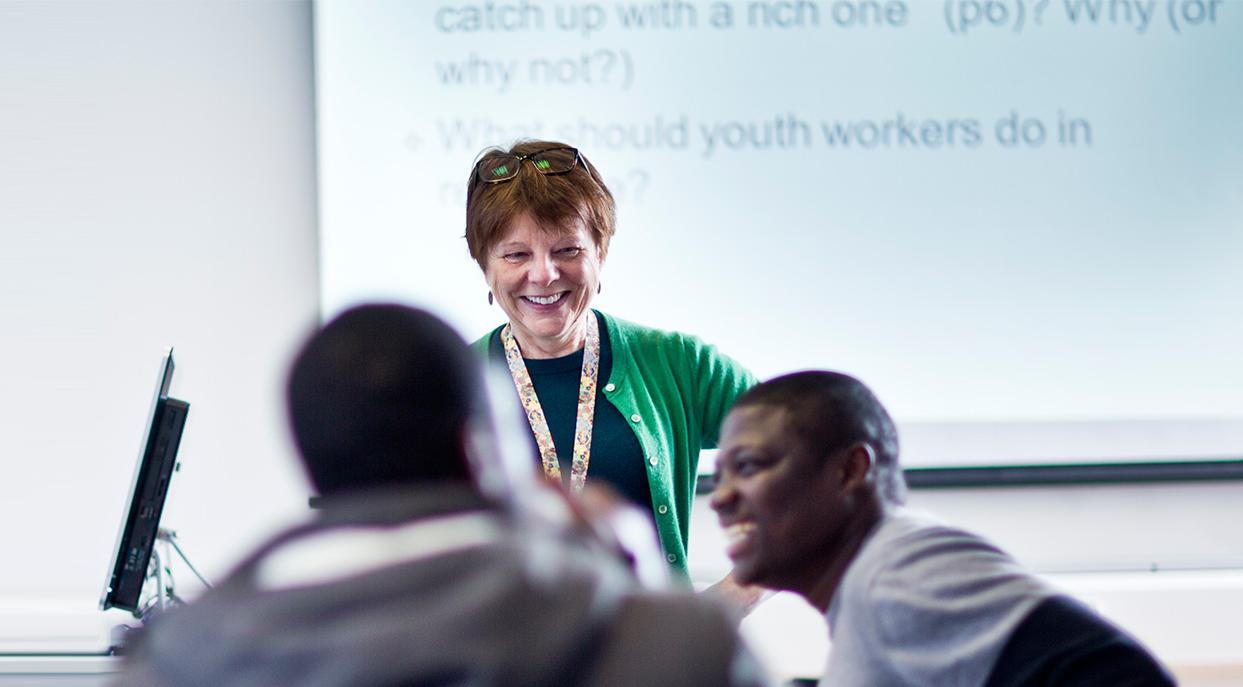 Teacher in classroom mentoring students