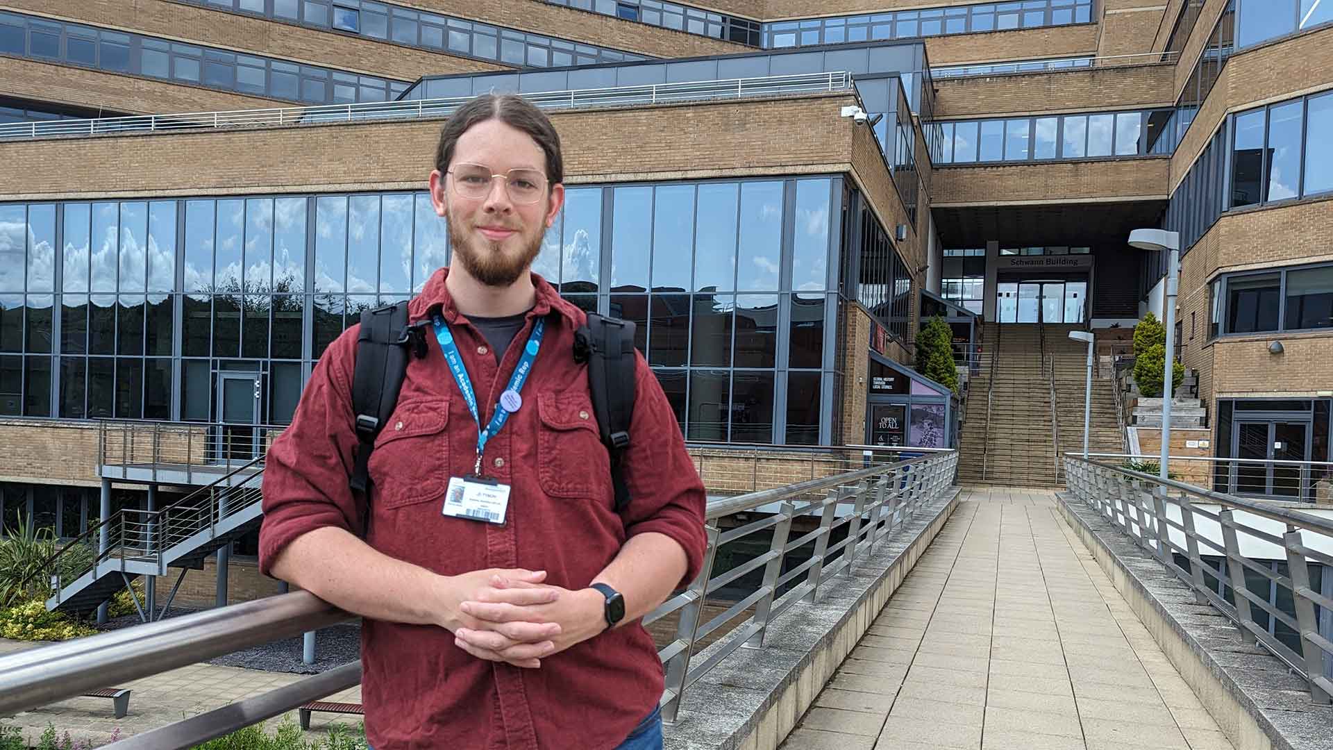Joe stood on a bridge on campus.
