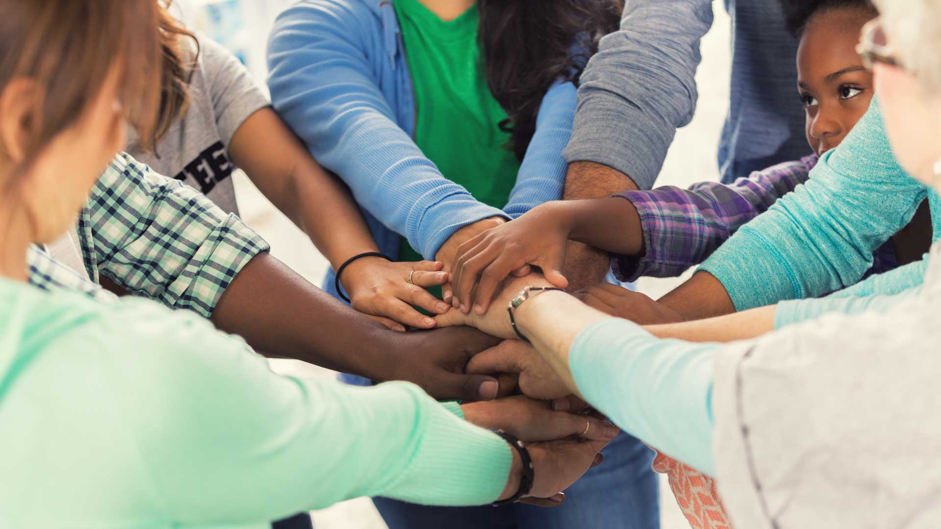 Multicultural hand holding